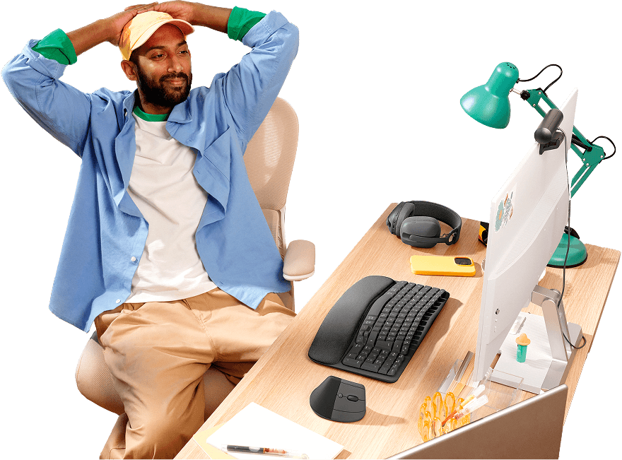 Man relaxing at a desk equipped with Logitech products